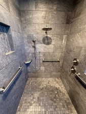Full bathroom featuring a tile shower