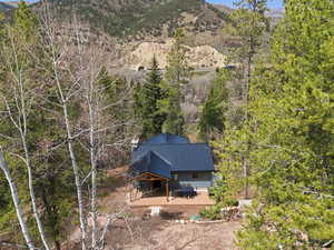 Aerial view of property and surrounding area with a mountainous background
