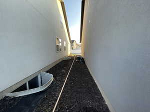View of side of property featuring stucco siding and a central AC unit