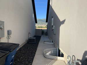 View of home's exterior with stucco siding, a mountain view, and a patio area
