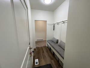 Mudroom with dark wood-style floors and baseboards