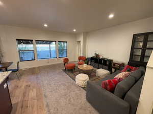 Living area with light wood-style floors and recessed lighting