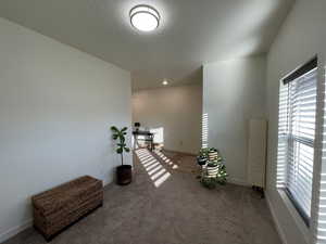 Spare room with light carpet and baseboards