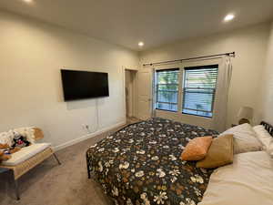 Carpeted bedroom featuring baseboards and recessed lighting