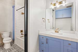 Full bathroom with vanity, tub / shower combination, and tile patterned flooring