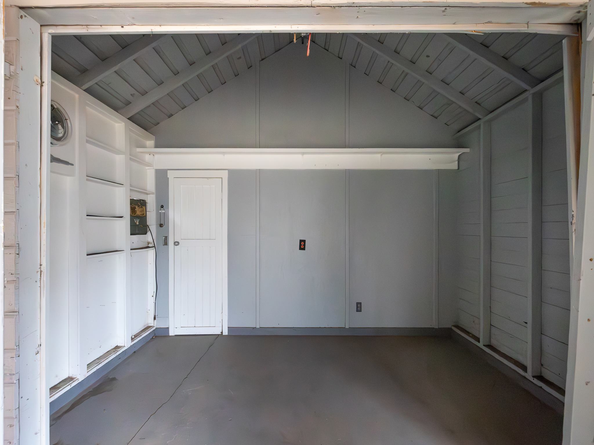 Garage featuring a decorative wall
