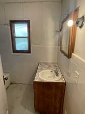 Full bathroom with tile walls and vanity