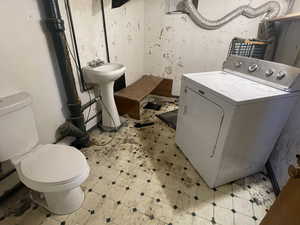 Downstairs half bath and laundry area.  Plenty of room to make this a full bathroom.