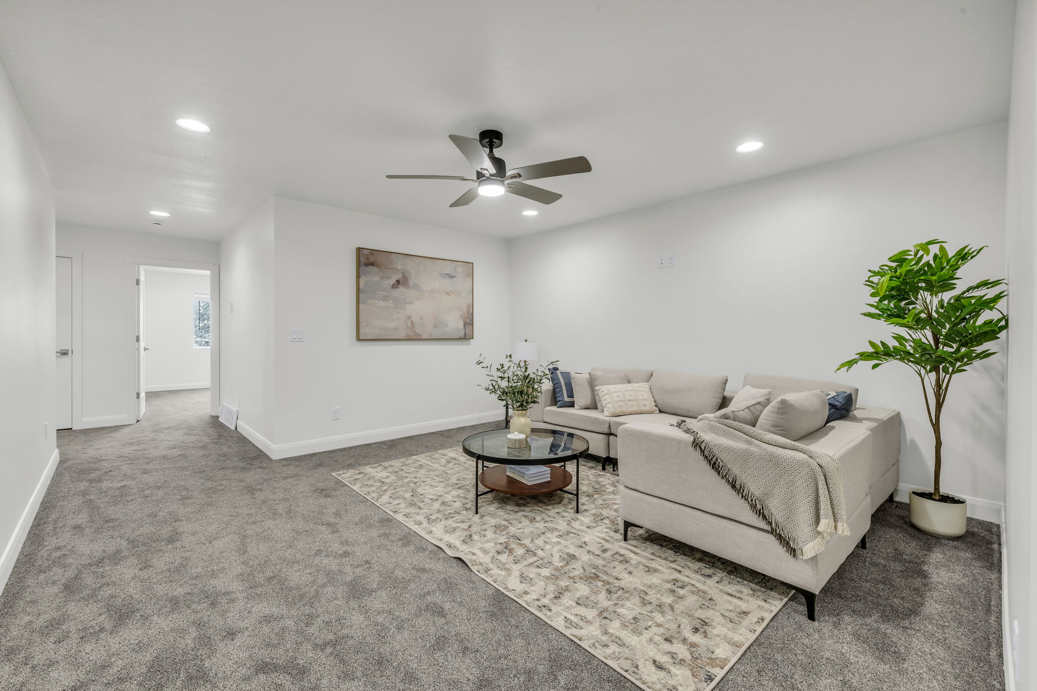 Living area featuring ceiling fan, carpet floors, and recessed lighting