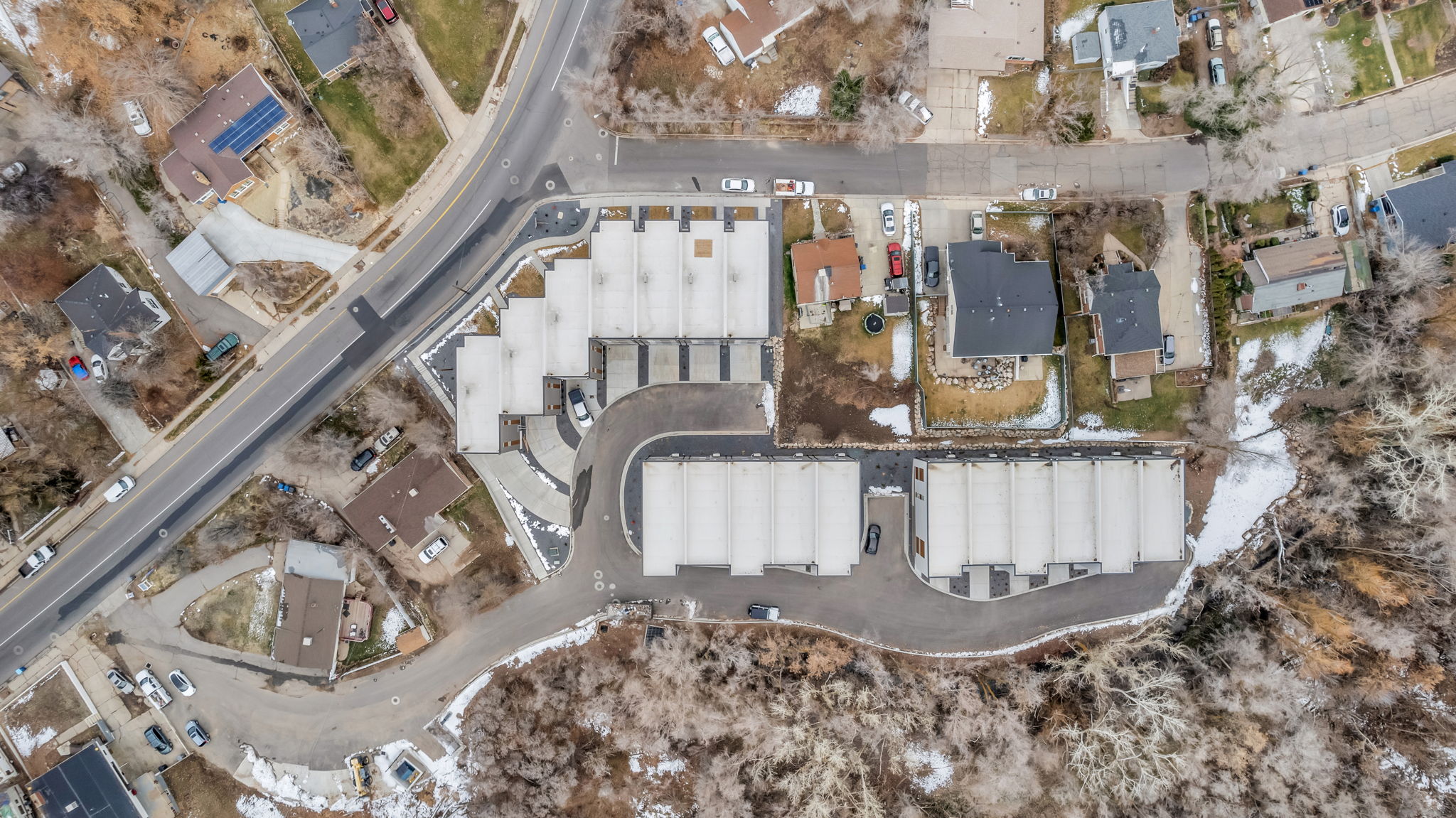 Aerial view of property and surrounding area featuring nearby suburban area