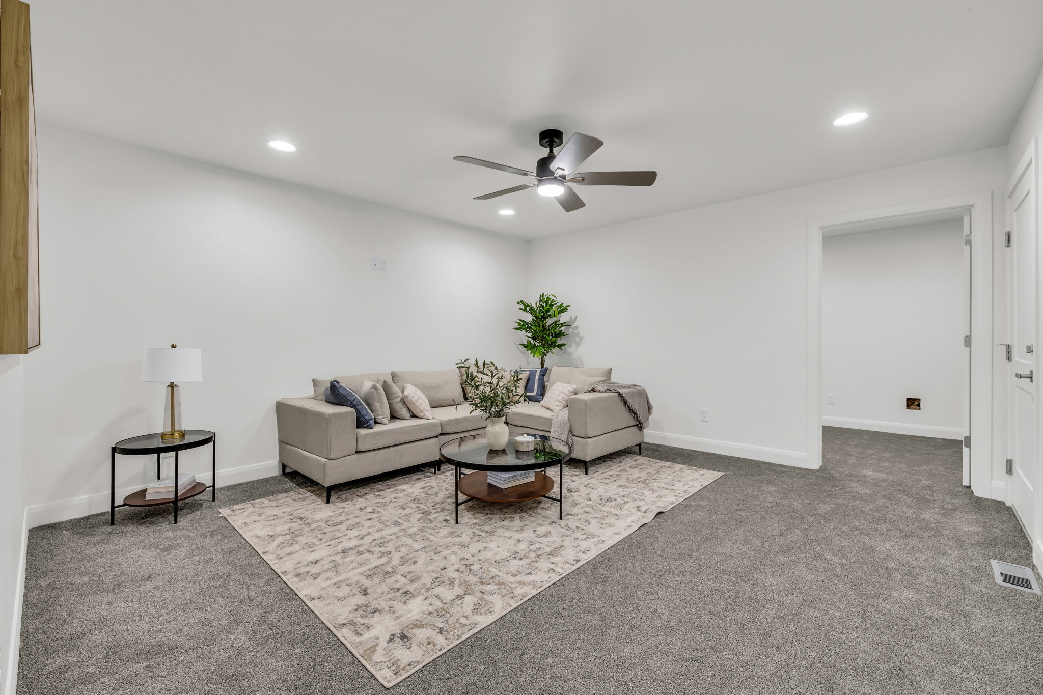 Living room featuring light colored carpet, ceiling fan, and recessed lighting