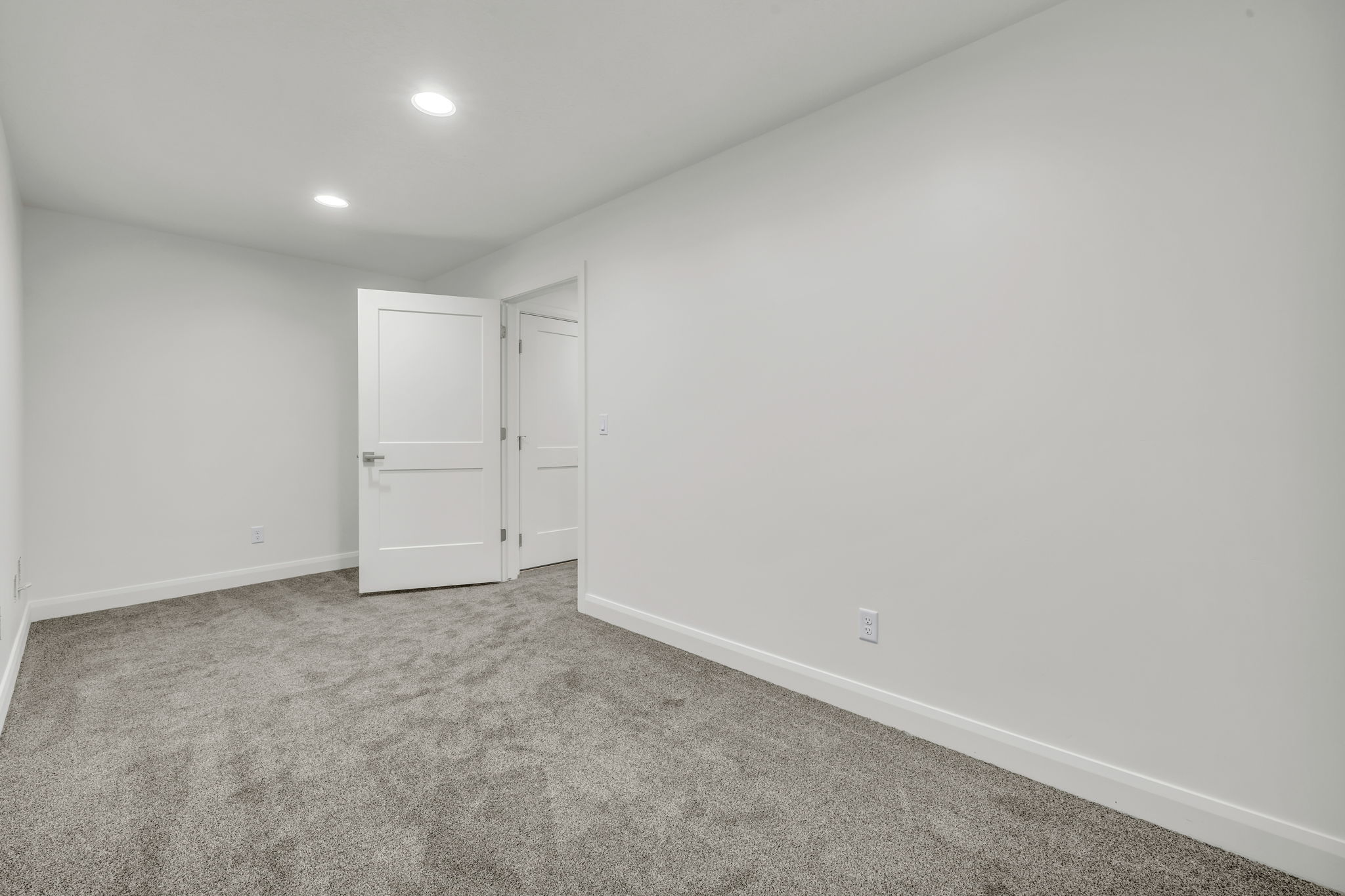 Unfurnished bedroom featuring light carpet and recessed lighting