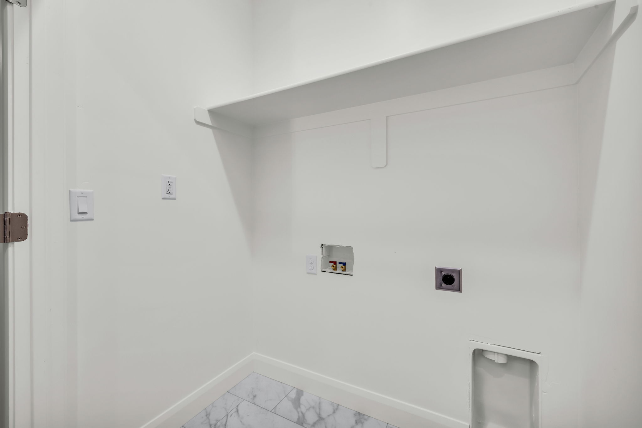 Laundry room with hookup for a washing machine, electric dryer hookup, and light marble finish floors