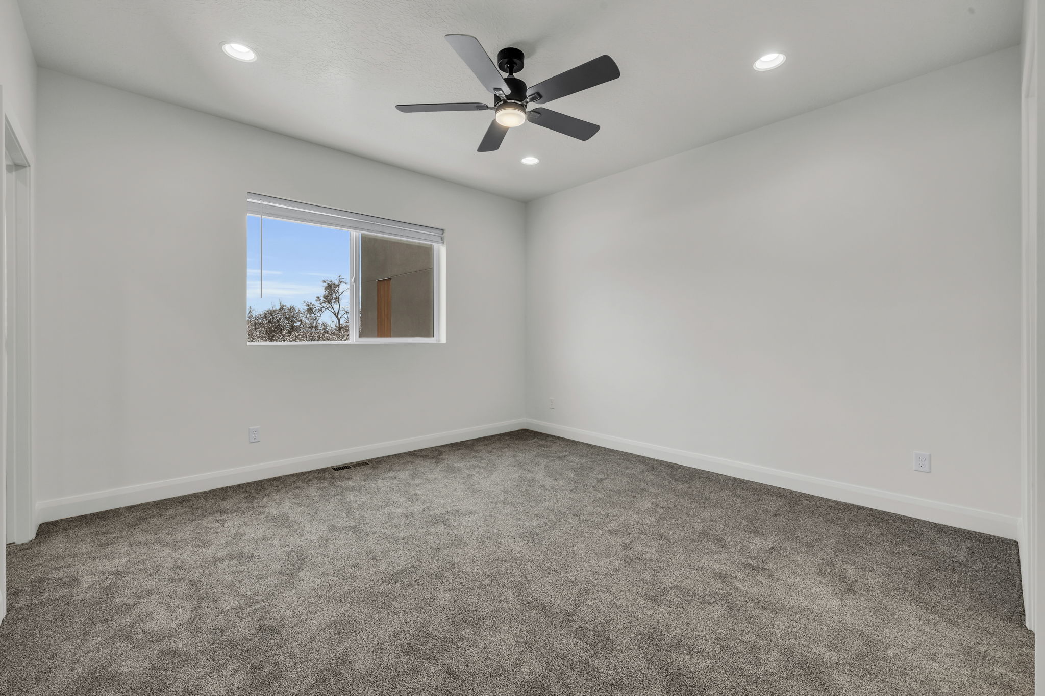 Empty room featuring carpet, recessed lighting, and ceiling fan