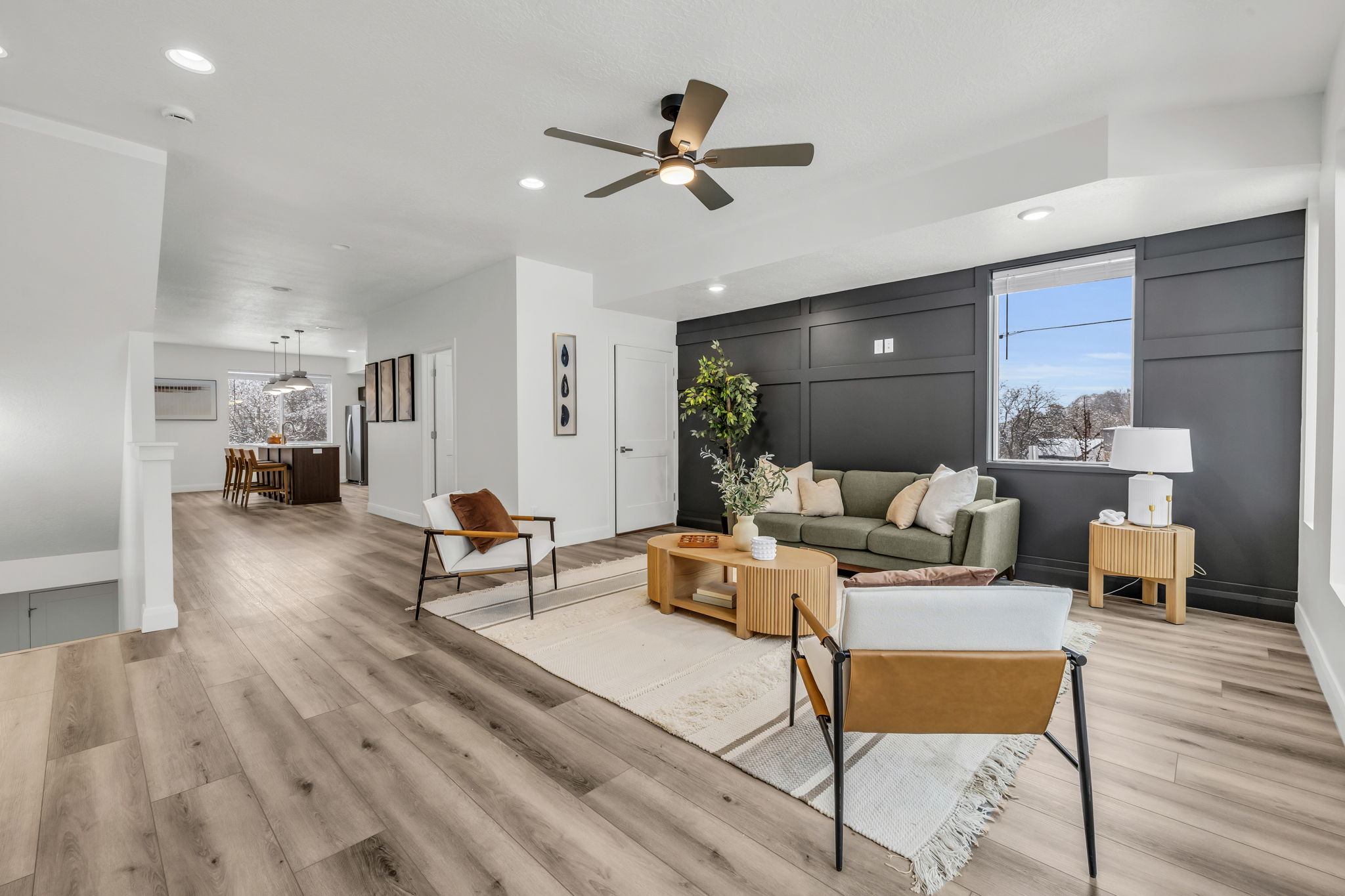 Living room with light wood-style floors, a ceiling fan, and recessed lighting