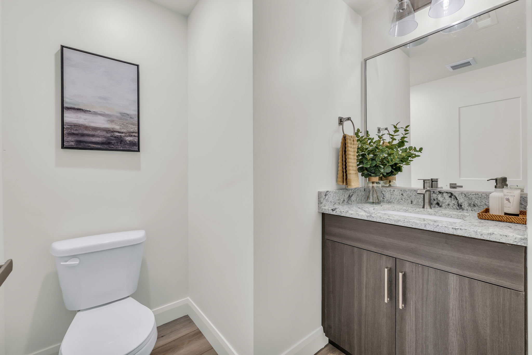Half bath featuring vanity and light wood-type flooring