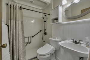 Bathroom featuring a stall shower and toilet