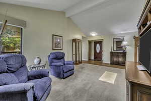 Living area with light colored carpet and baseboards