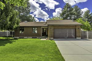 Ranch-style house with a shingled roof, driveway, brick siding, and a garage