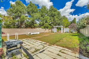 Fenced backyard with a pergola and a patio