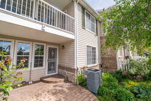 View of exterior entry with a patio