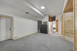 Unfurnished bedroom with light carpet and baseboards