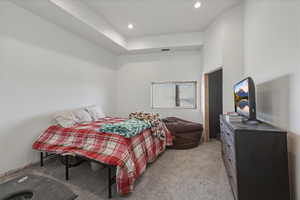 Bedroom featuring light carpet and recessed lighting