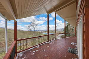 Wooden deck with a water and mountain view