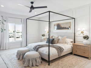 Carpeted bedroom with ceiling fan, recessed lighting, and a decorative wall