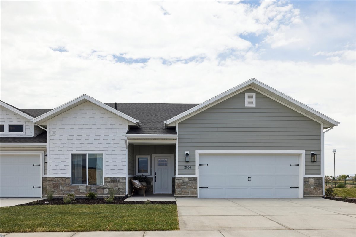 Craftsman inspired home with stone siding, driveway, covered porch, a garage, and a shingled roof