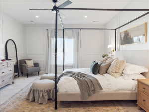 Carpeted bedroom featuring a decorative wall, ceiling fan, and recessed lighting