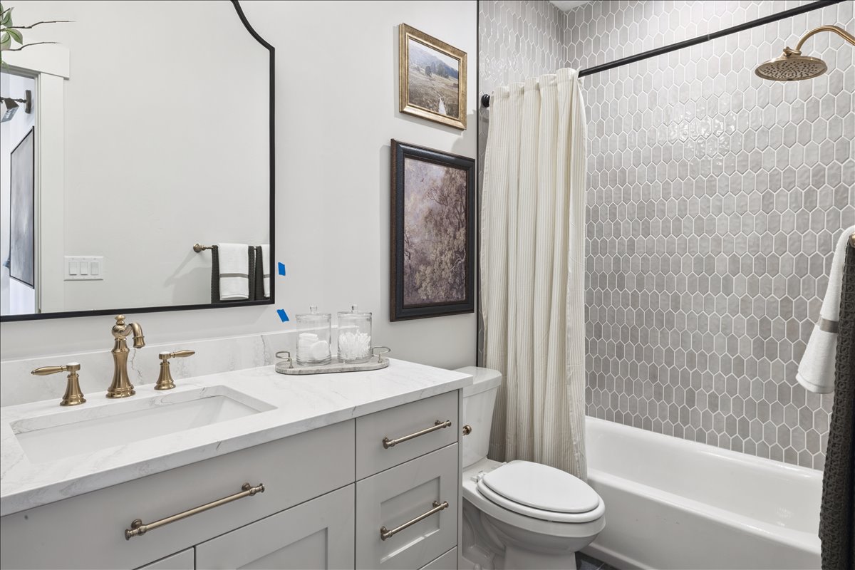 Full bath featuring vanity and shower / bath combination with curtain