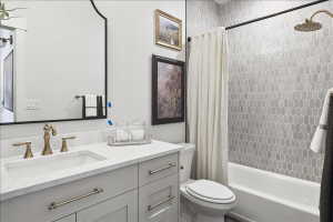Full bath featuring vanity and shower / bath combination with curtain
