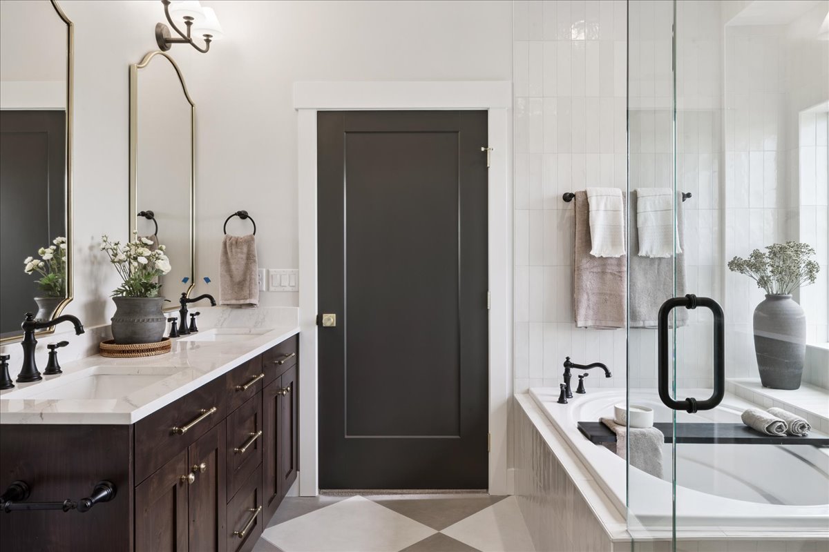 Full bathroom with double vanity and a garden tub