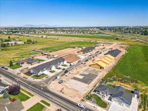 Aerial view of property and surrounding area with nearby suburban area and a large body of water