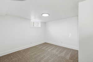 Below grade area with baseboards and carpet