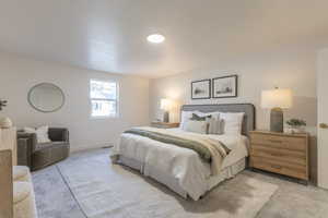 Bedroom featuring light colored carpet and baseboards