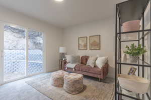 Carpeted living area with baseboards