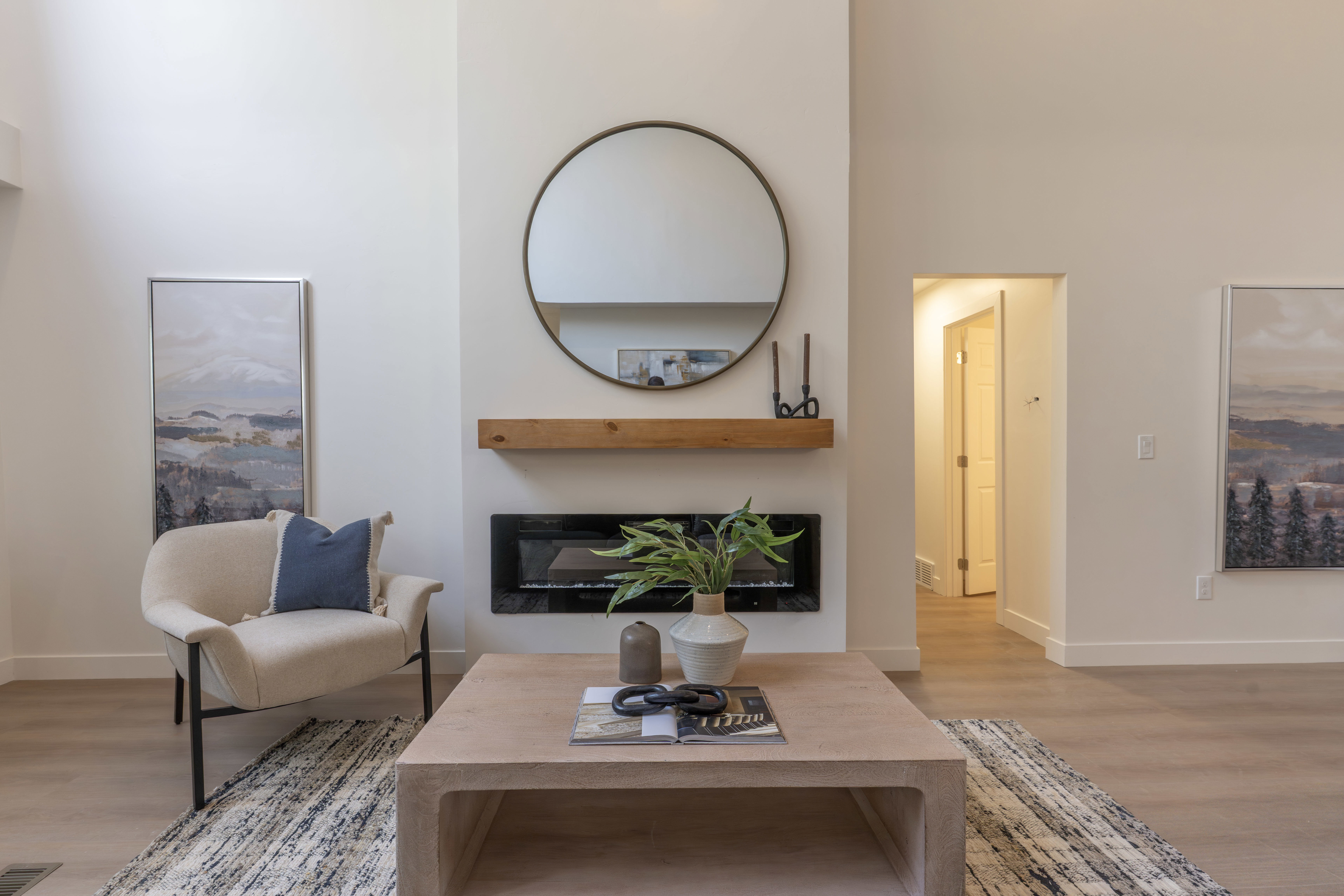 Living area featuring light wood finished floors and a glass covered fireplace