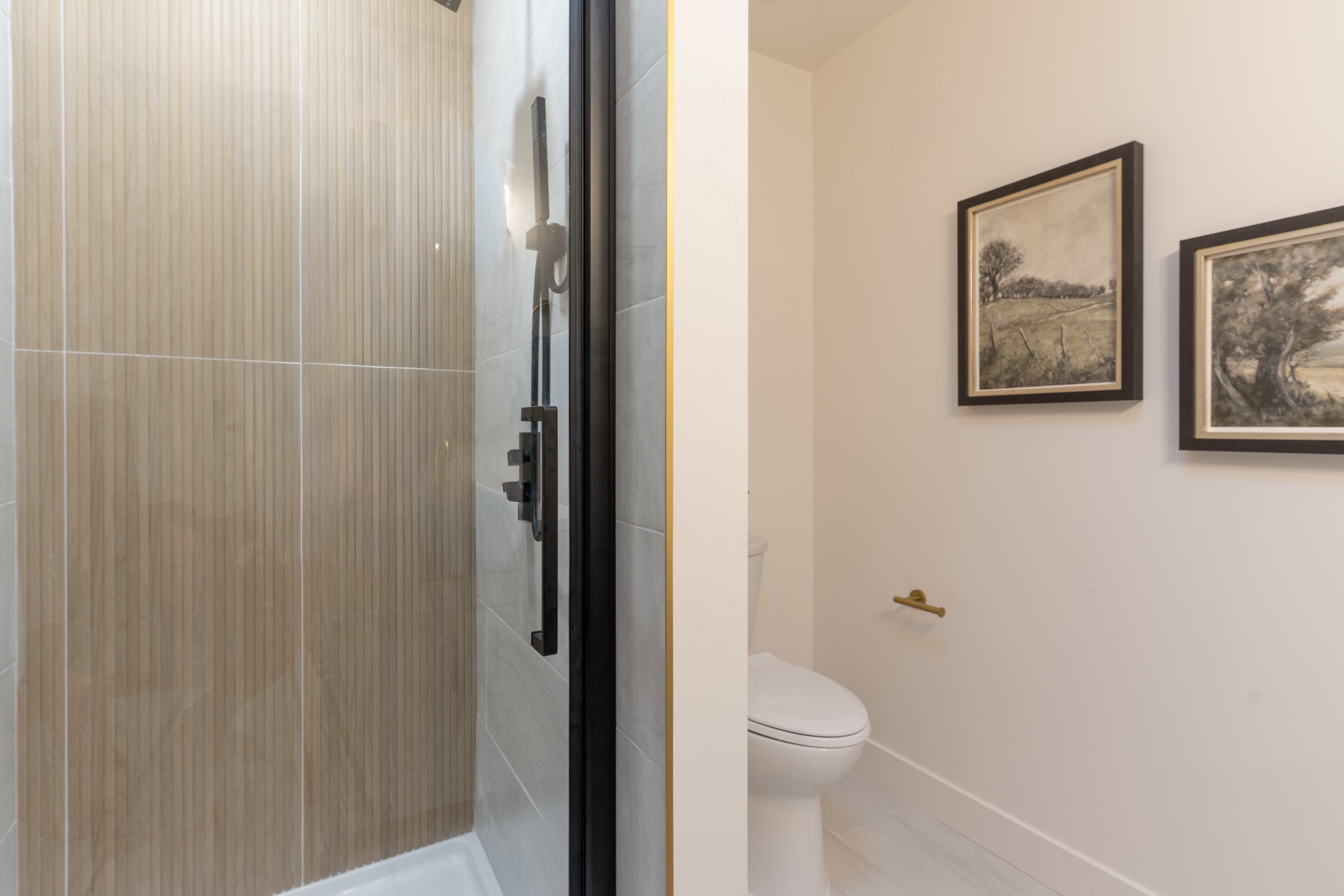 Bathroom featuring a stall shower and light tile patterned floors