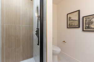 Bathroom featuring a stall shower and light tile patterned floors