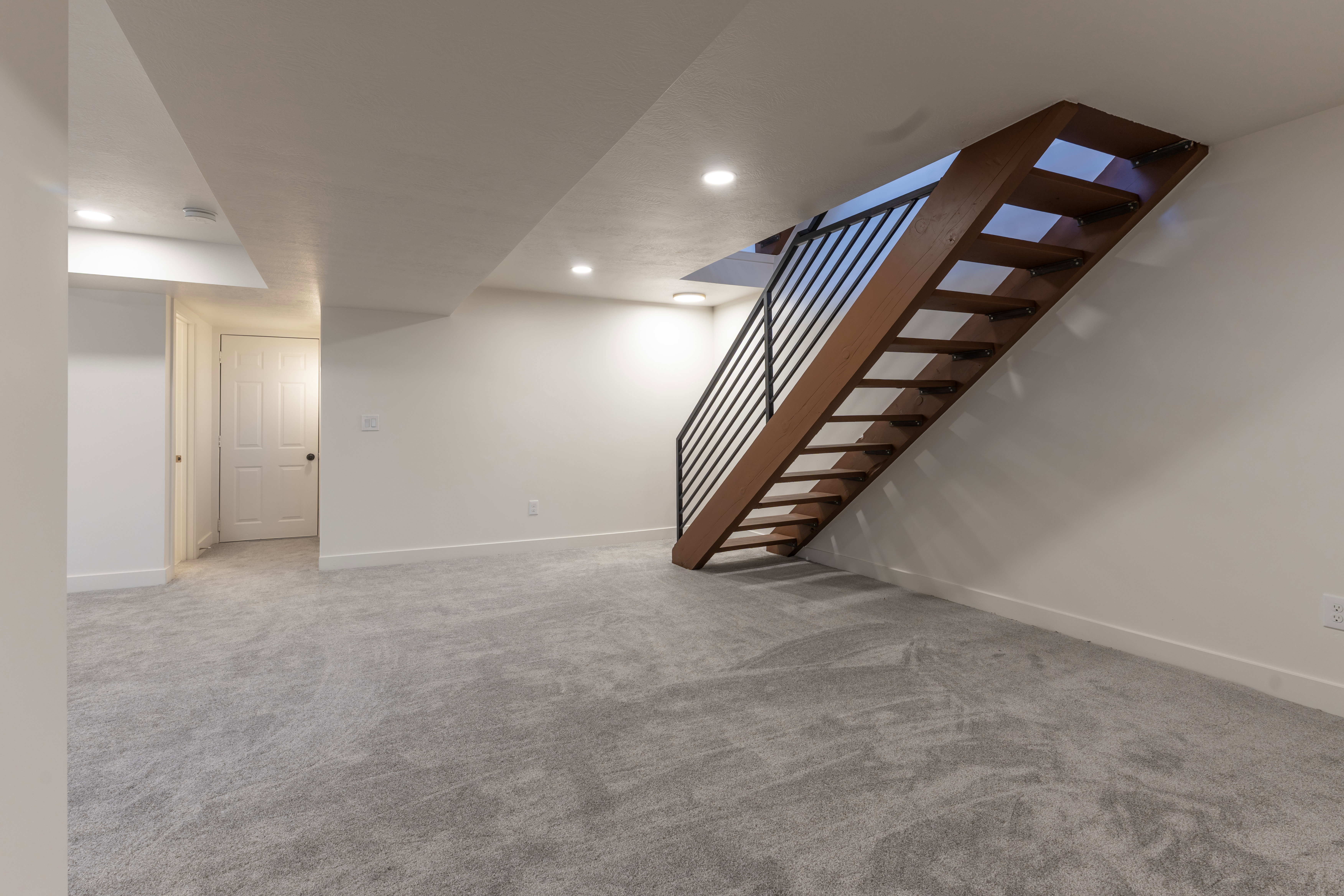 Finished below grade area with light carpet and recessed lighting
