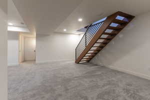 Finished below grade area with light carpet and recessed lighting