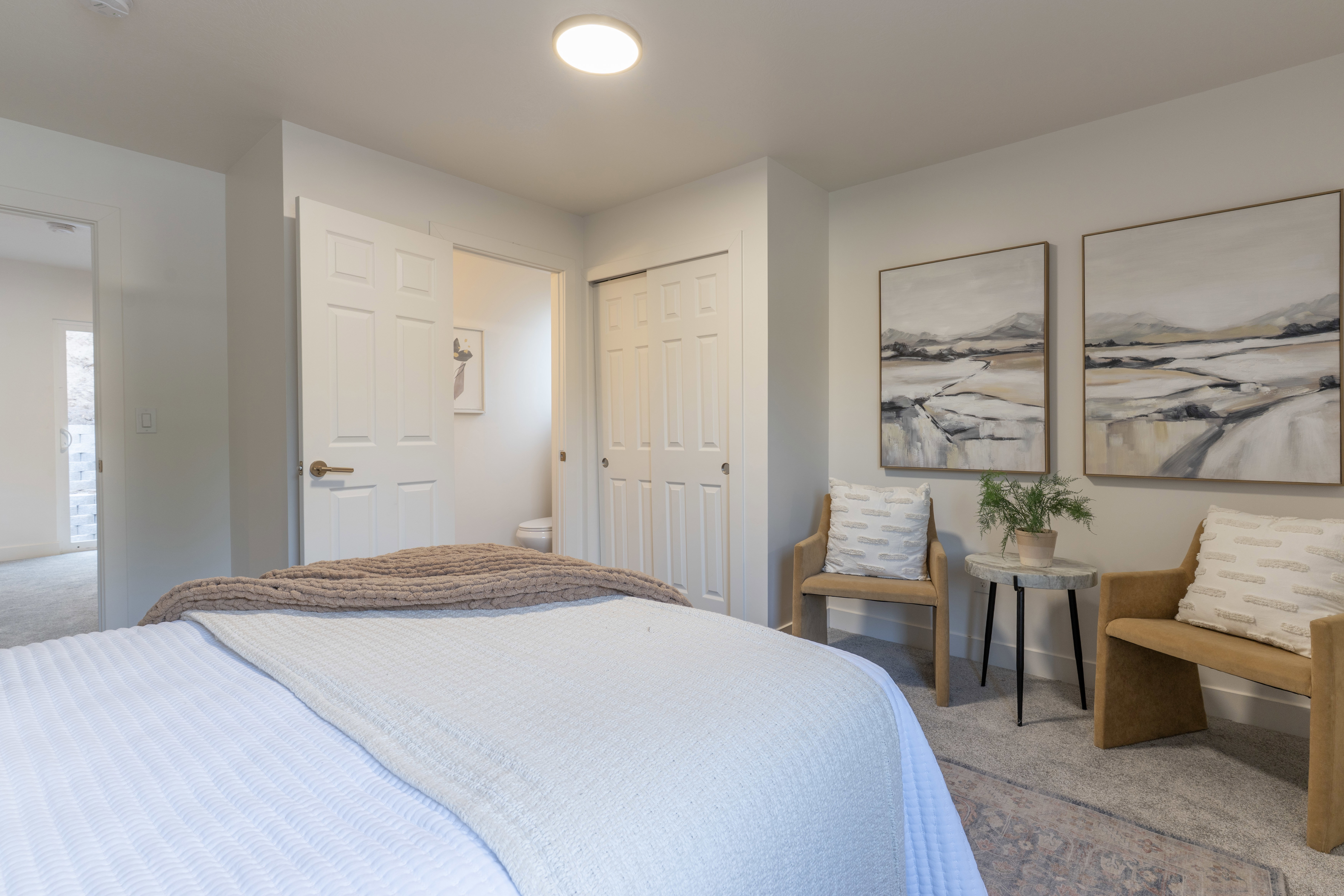 Bedroom featuring carpet flooring, a closet, and ensuite bath