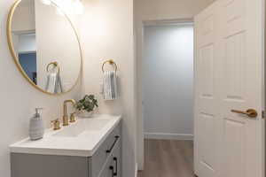 Bathroom featuring vanity and light wood finished floors