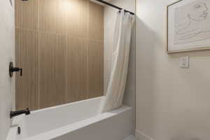 Bathroom featuring shower / bath combination with curtain