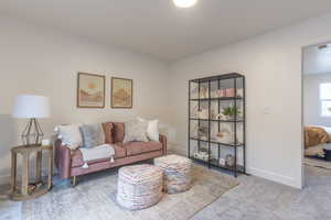 Carpeted living room with baseboards