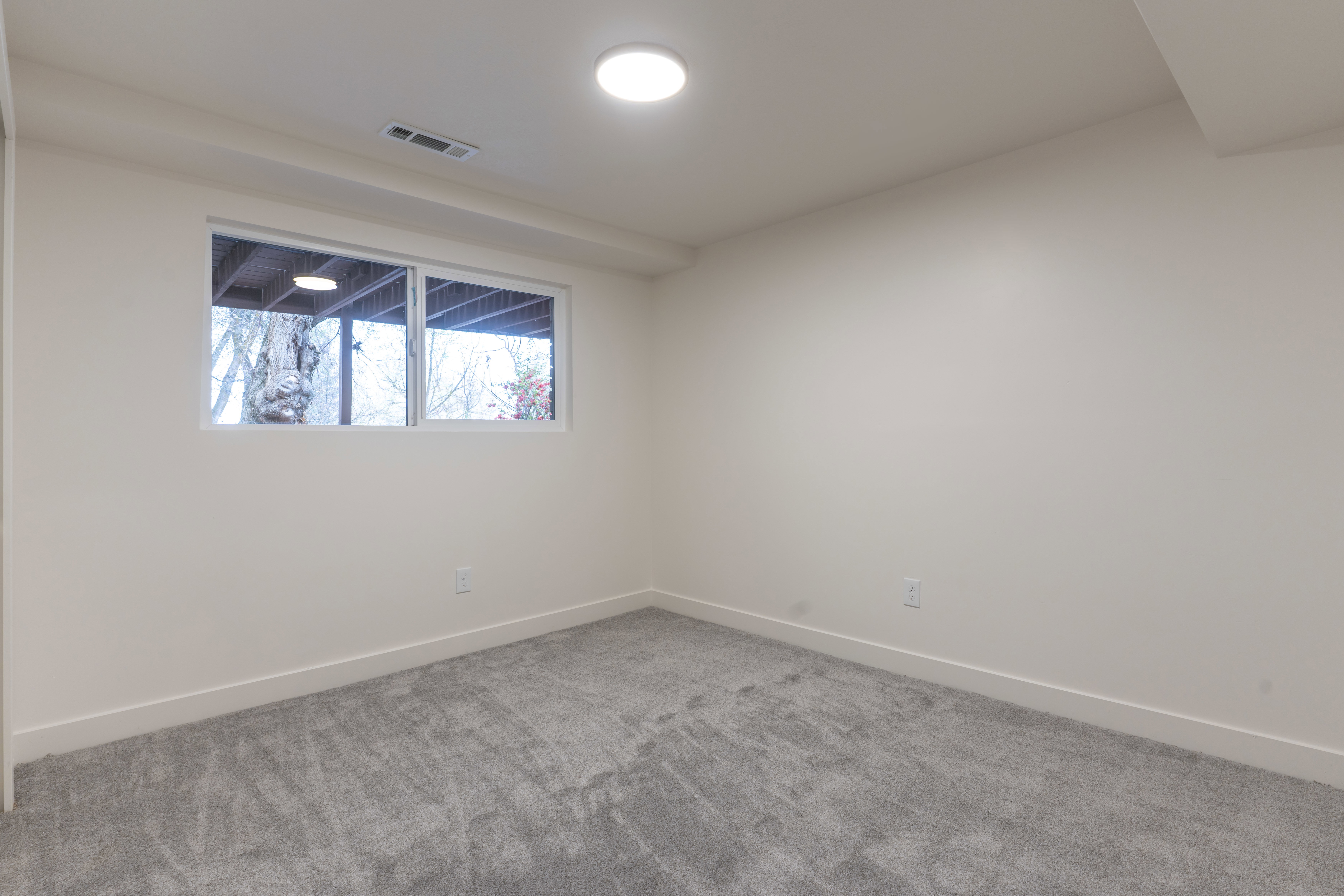 Carpeted empty room with baseboards