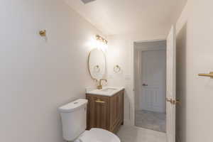 Half bath with vanity and light carpet