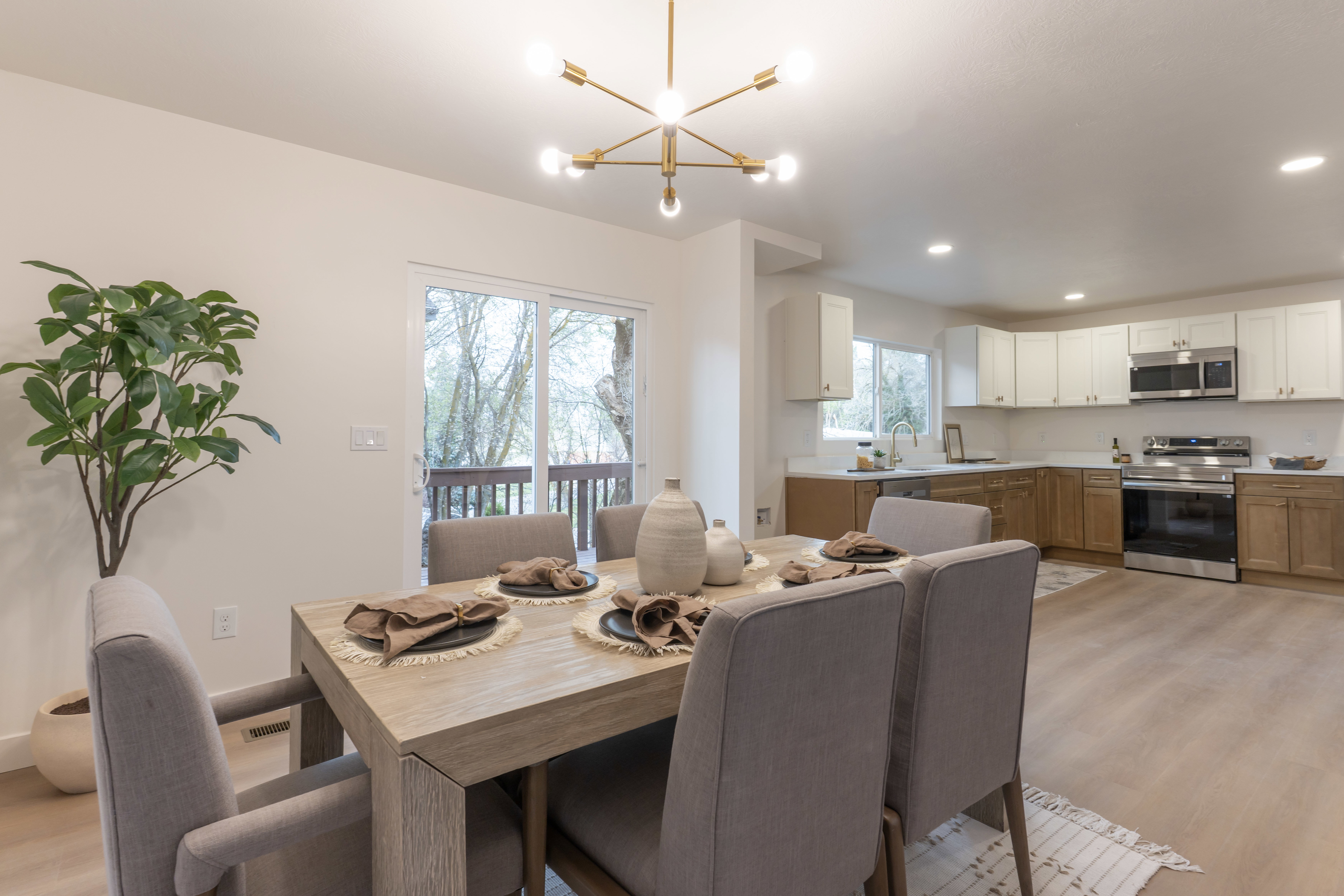 Dining space with light wood-style flooring and a chandelier